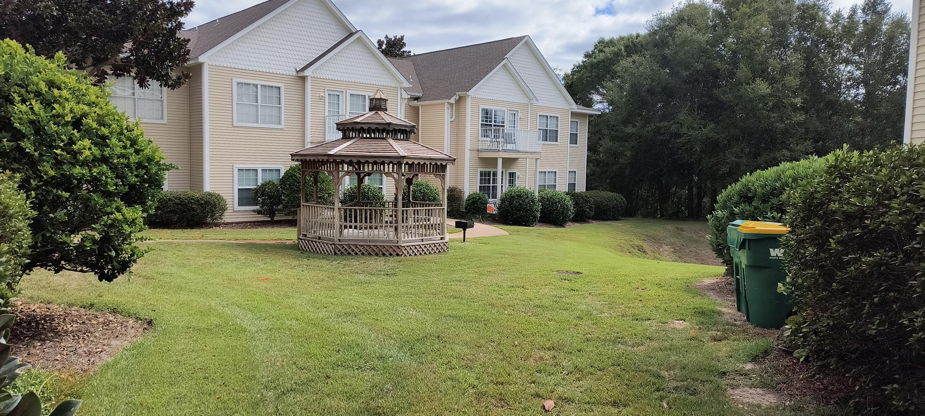 1501 Partin Drive North, Unit 164 Niceville, FL 32578 - Photo 3 of 23 a front view of a house with a garden