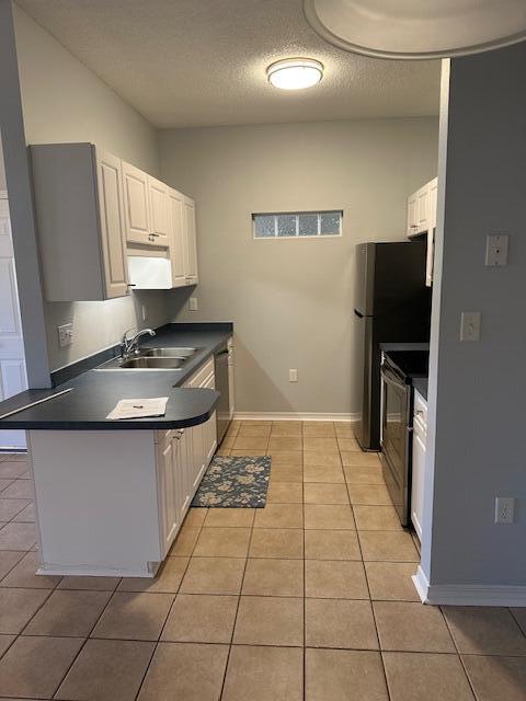 1501 Partin Drive North, Unit 164 Niceville, FL 32578 - Photo 8 of 23 a kitchen with a sink a stove and a refrigerator