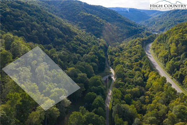 a view of a houses with a lush green hillside