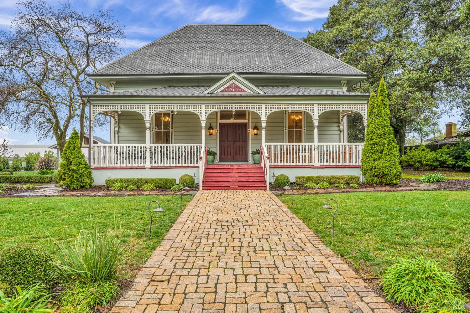 a front view of a house with a yard and porch