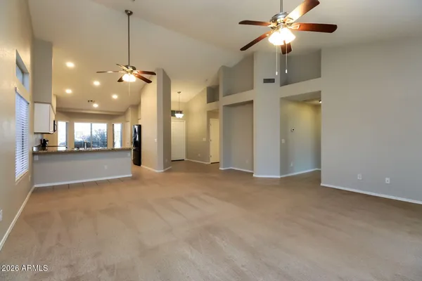 a view of an empty room with a kitchen