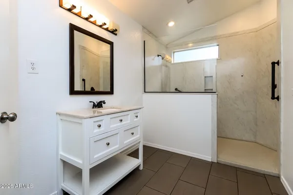 a bathroom with a double vanity sink mirror and shower