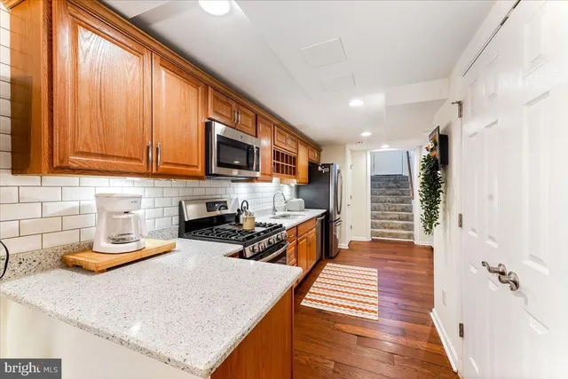 a kitchen with sink refrigerator and microwave