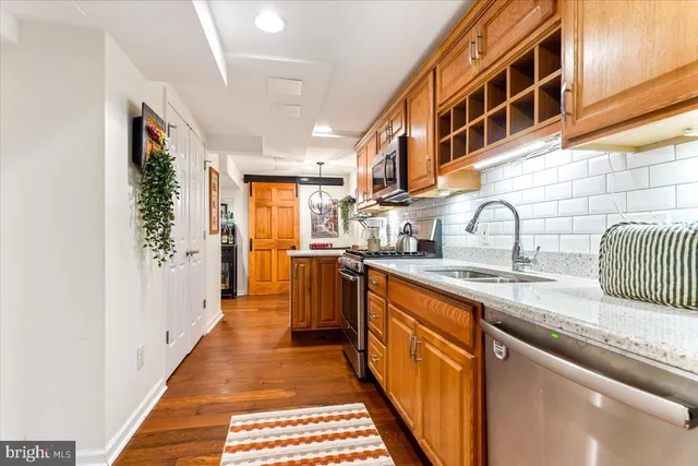 a kitchen with stainless steel appliances a sink and cabinets