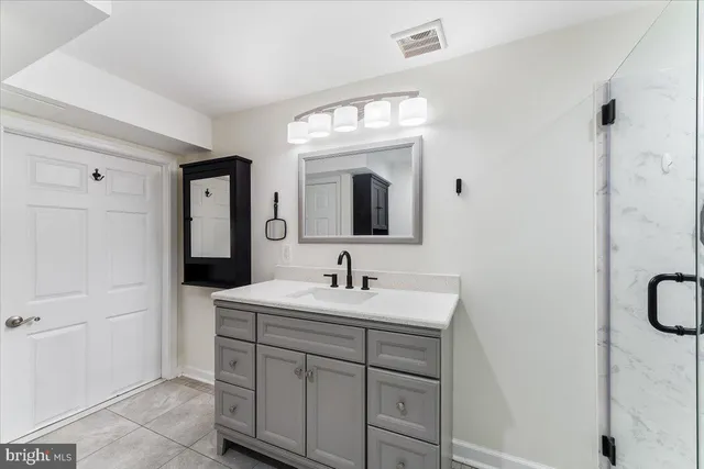 a bathroom with a sink vanity and a mirror
