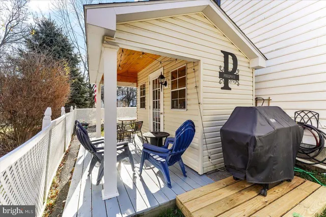 a view of a patio with table and chairs and wooden floor