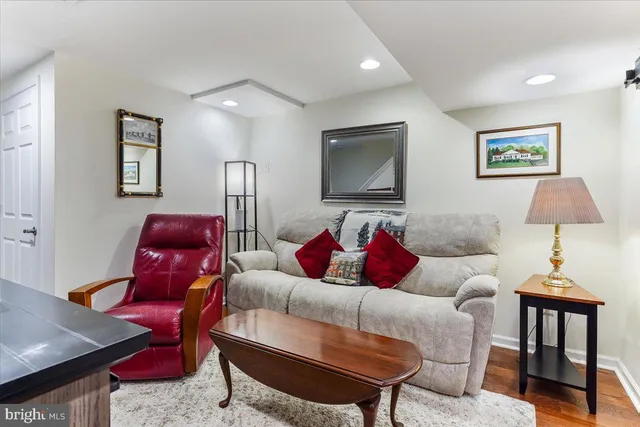 a living room with furniture and a lamp