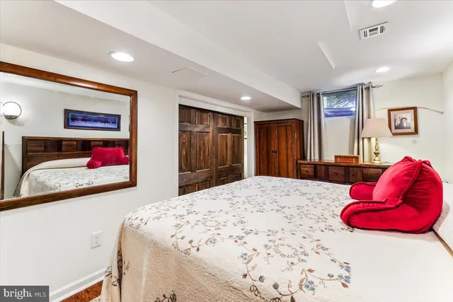 a bedroom with a bed and a dresser