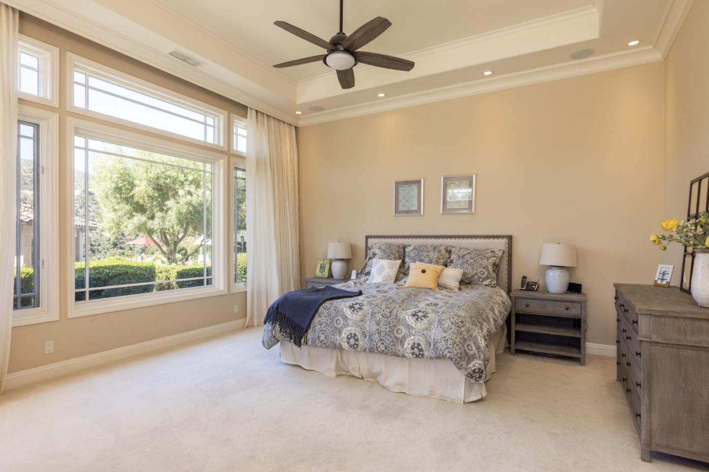 19831 Spring Ridge Terrace Salinas, CA 93908 - Photo 17 of 49 a bedroom with a large bed and a chandelier fan