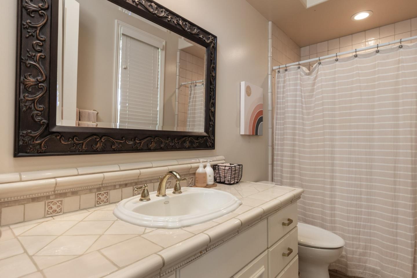 19831 Spring Ridge Terrace Salinas, CA 93908 - Photo 24 of 49 a bathroom with a sink a toilet and mirror