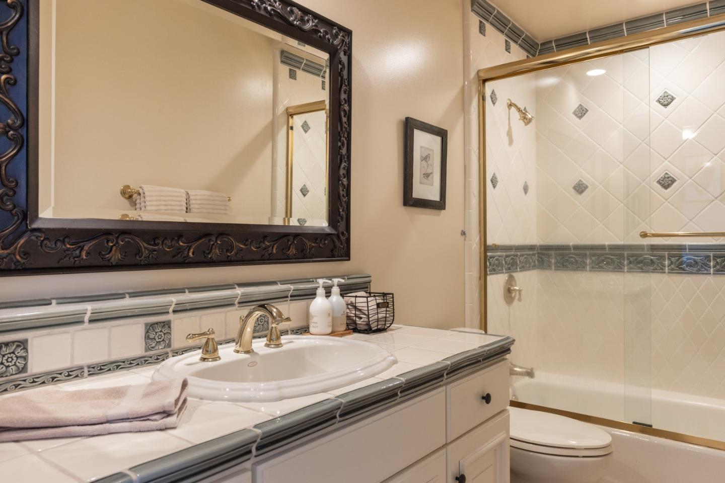 19831 Spring Ridge Terrace Salinas, CA 93908 - Photo 26 of 49 a bathroom with a granite countertop sink mirror vanity and toilet