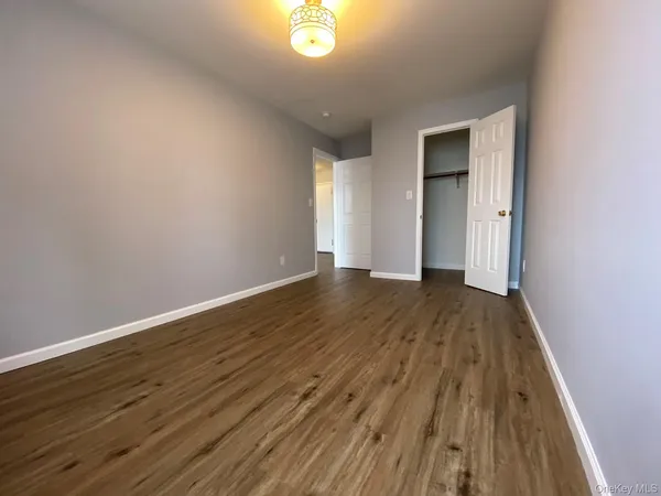 a view of a room with wooden floor and window