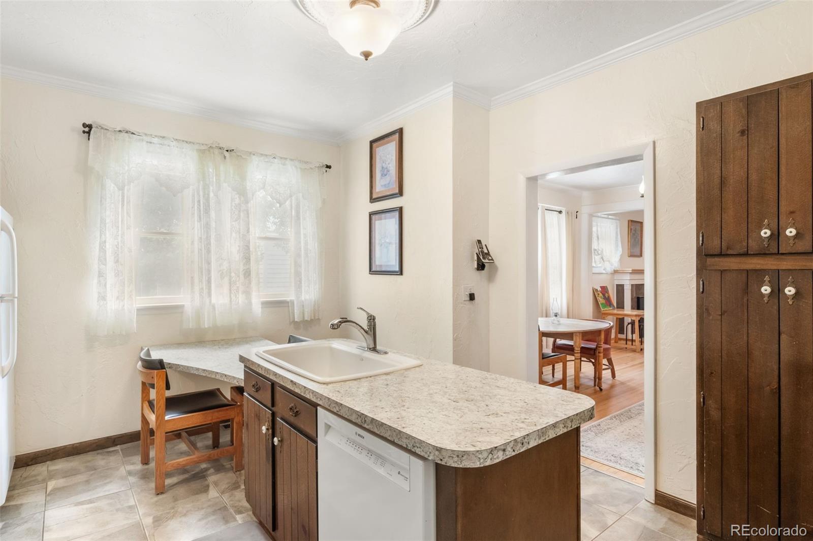 6044 Columbine Street Rye, CO 81069 - Photo 14 of 31 a room with a table chairs and a refrigerator