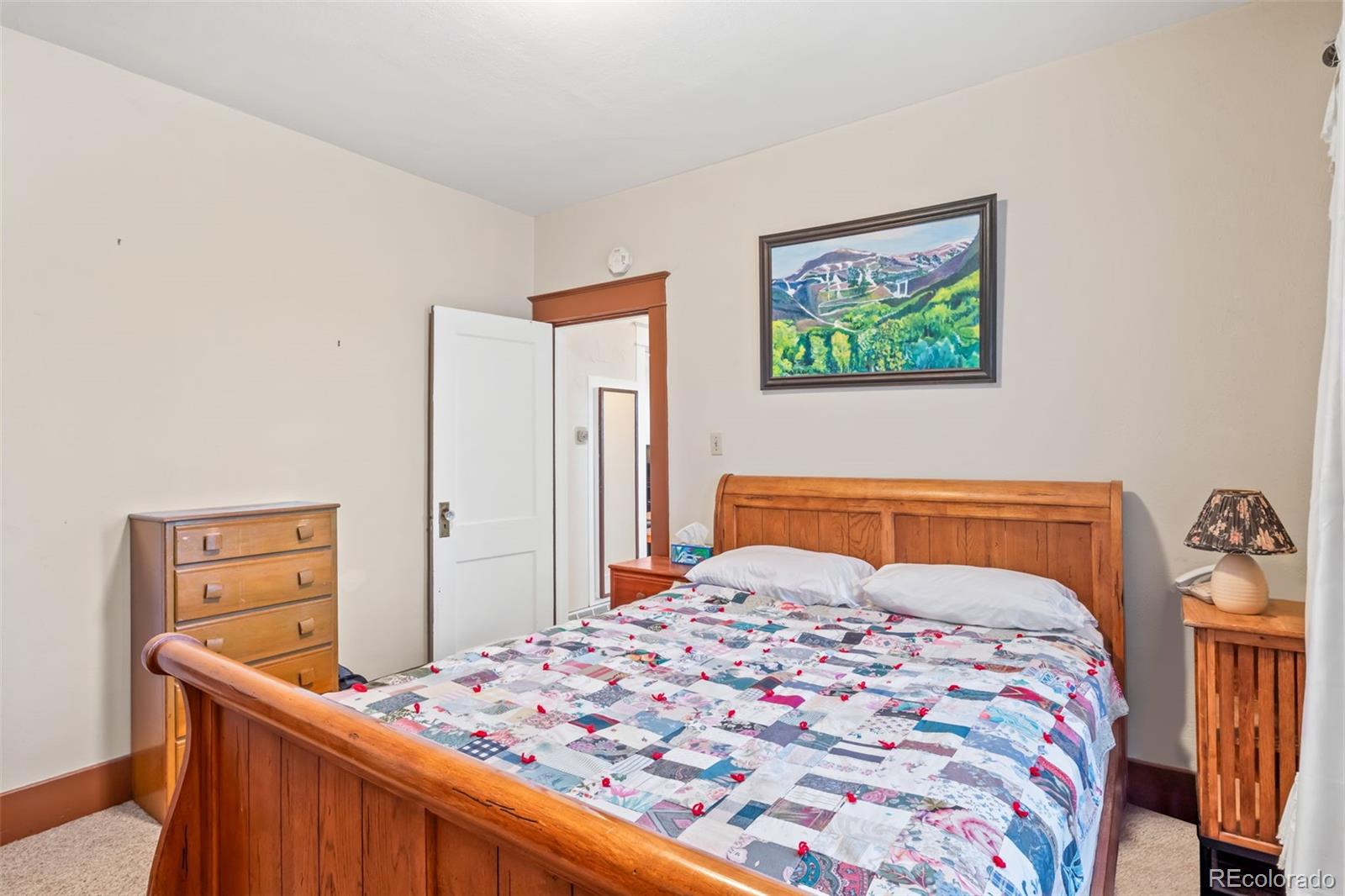 6044 Columbine Street Rye, CO 81069 - Photo 21 of 31 a bedroom with a bed and a dresser