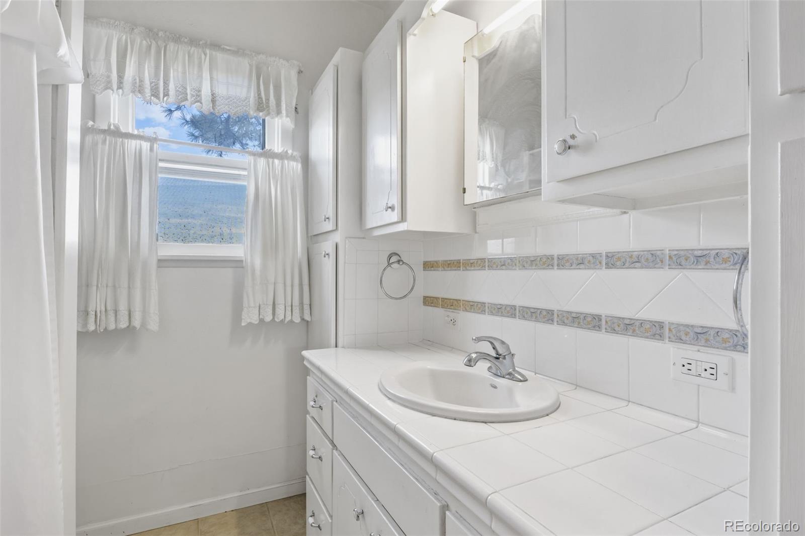 6044 Columbine Street Rye, CO 81069 - Photo 22 of 31 a bathroom with a sink and a mirror