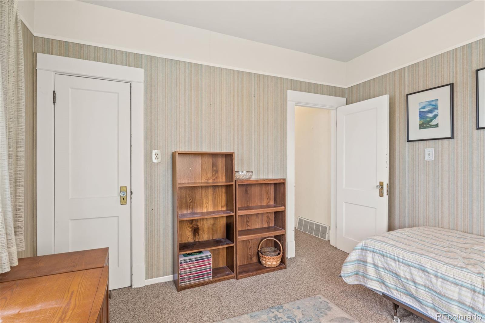6044 Columbine Street Rye, CO 81069 - Photo 24 of 31 a room with a bed and a lamp on desk