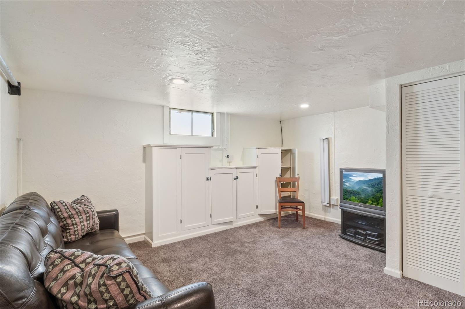 6044 Columbine Street Rye, CO 81069 - Photo 26 of 31 a living room with furniture and a wooden floor