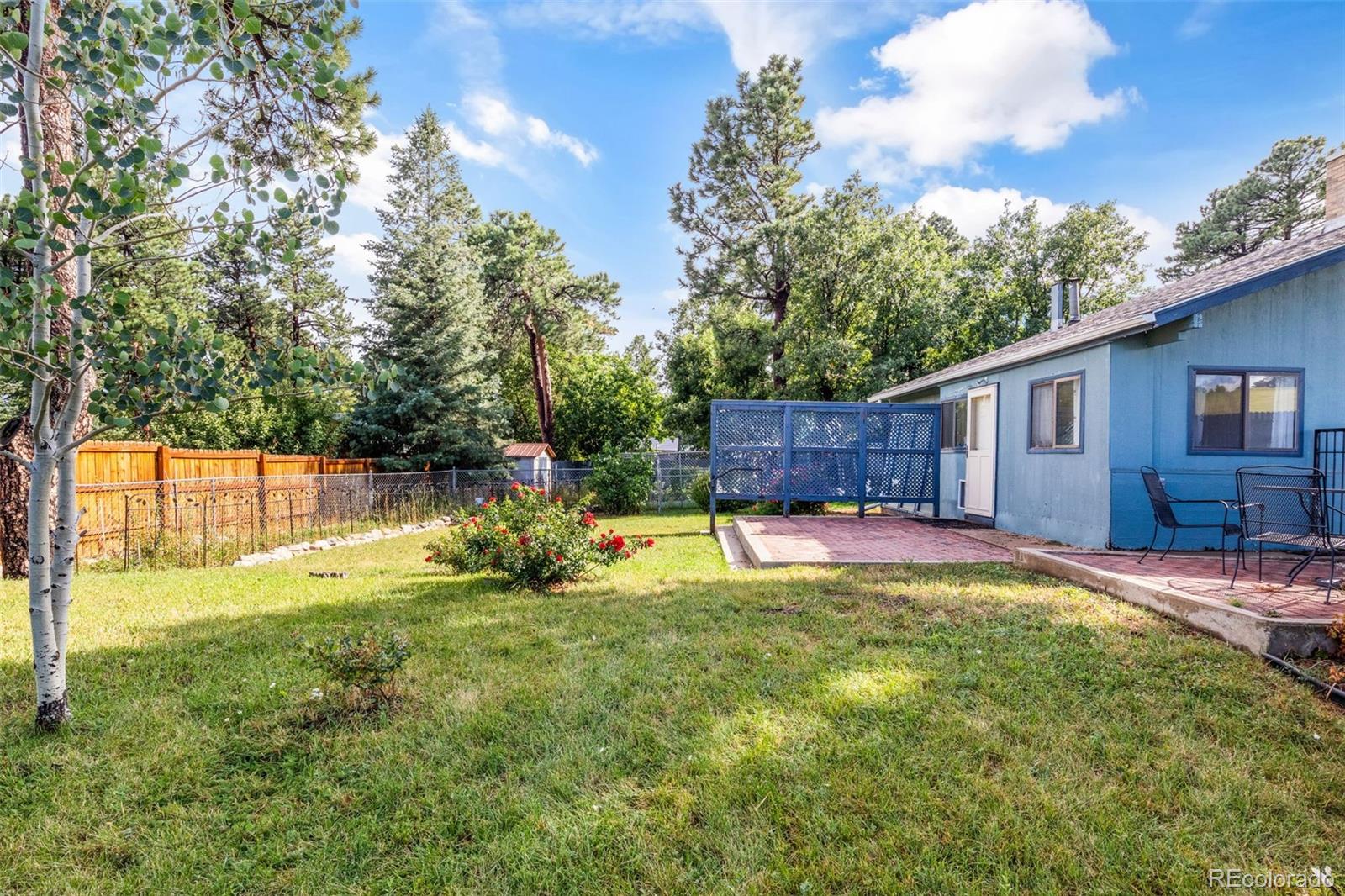 6044 Columbine Street Rye, CO 81069 - Photo 29 of 31 a view of a house with a yard patio and fire pit