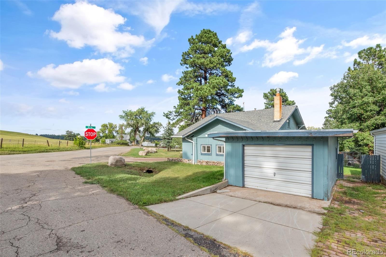 6044 Columbine Street Rye, CO 81069 - Photo 5 of 31 a front view of a house with a yard and garage