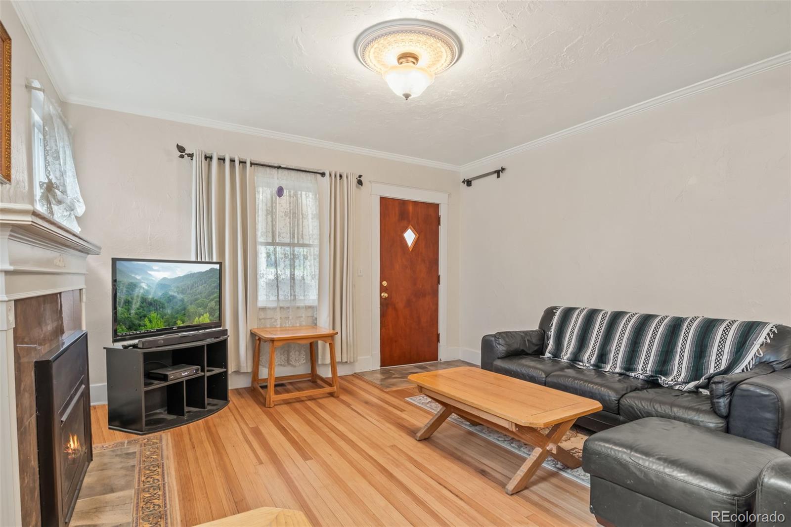 6044 Columbine Street Rye, CO 81069 - Photo 9 of 31 a bedroom with a bed and a fireplace