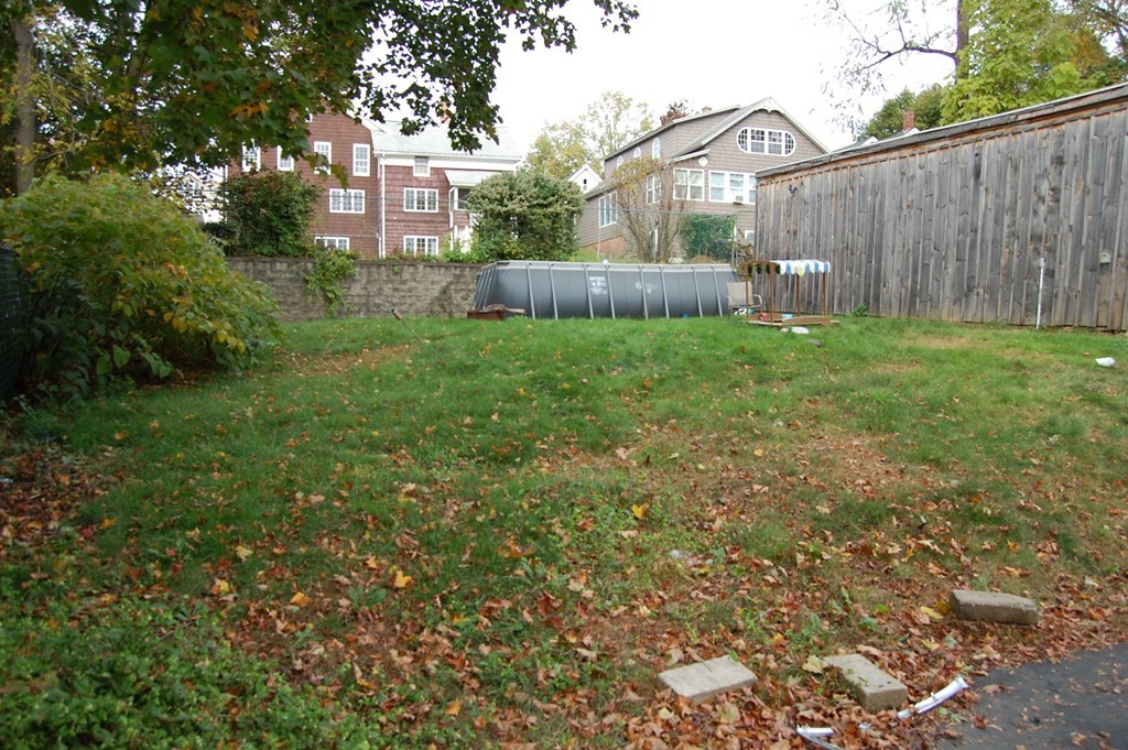 33 1/2 High Street Ware, MA 01082 - Photo 4 of 22 a view of a back yard with an tree and wooden fence