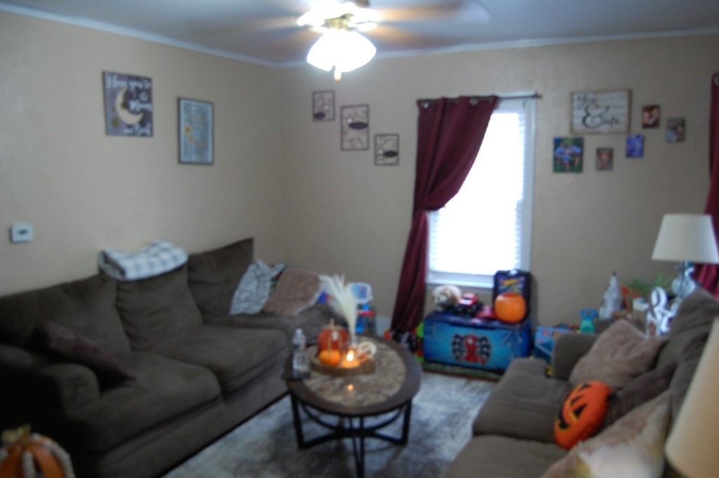 33 1/2 High Street Ware, MA 01082 - Photo 8 of 22 a living room with furniture and a chandelier