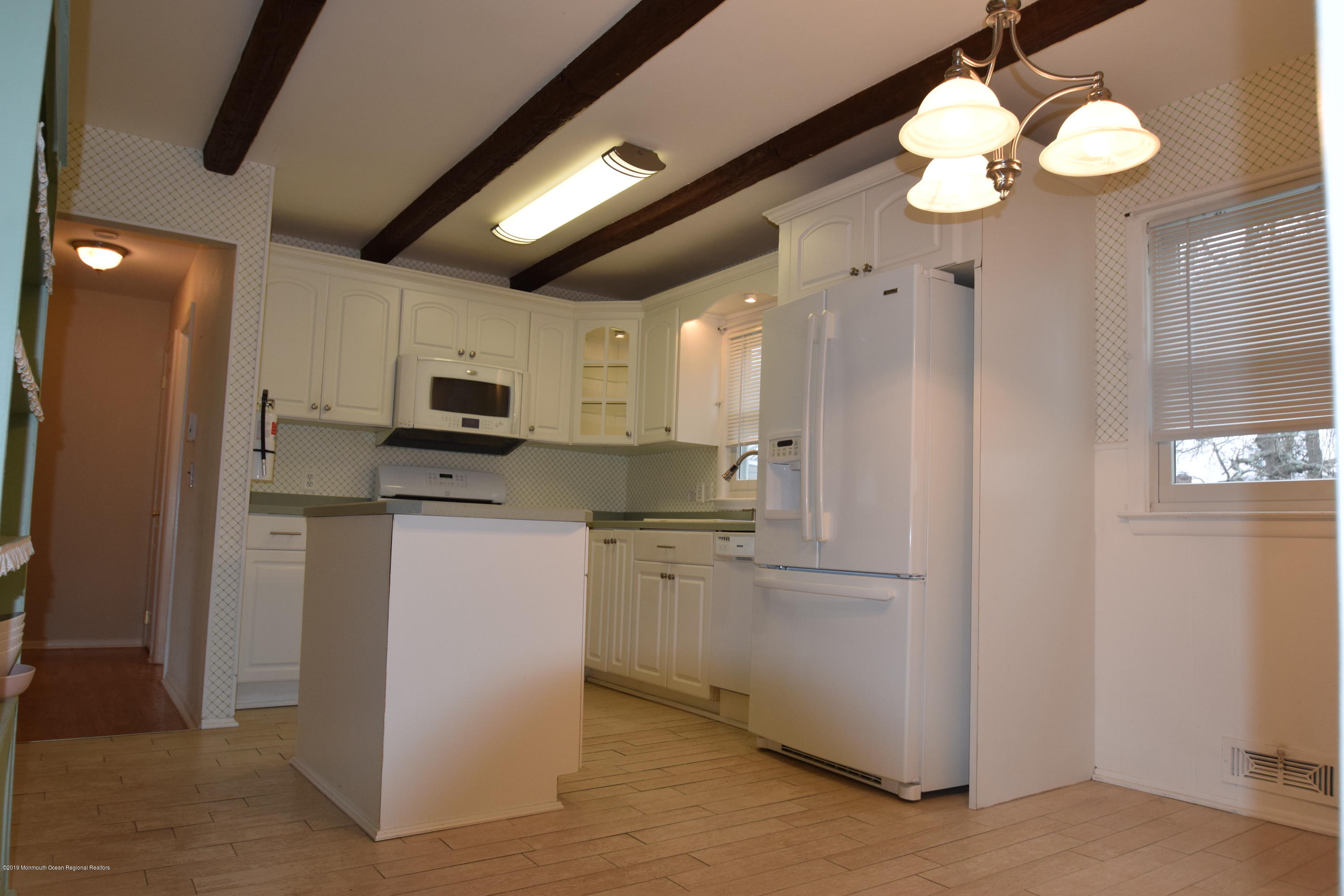1519 Treeneedle Road Point Pleasant, NJ 08742 - Photo 3 of 21 a kitchen with stainless steel appliances granite countertop a refrigerator a stove a sink and a microwave