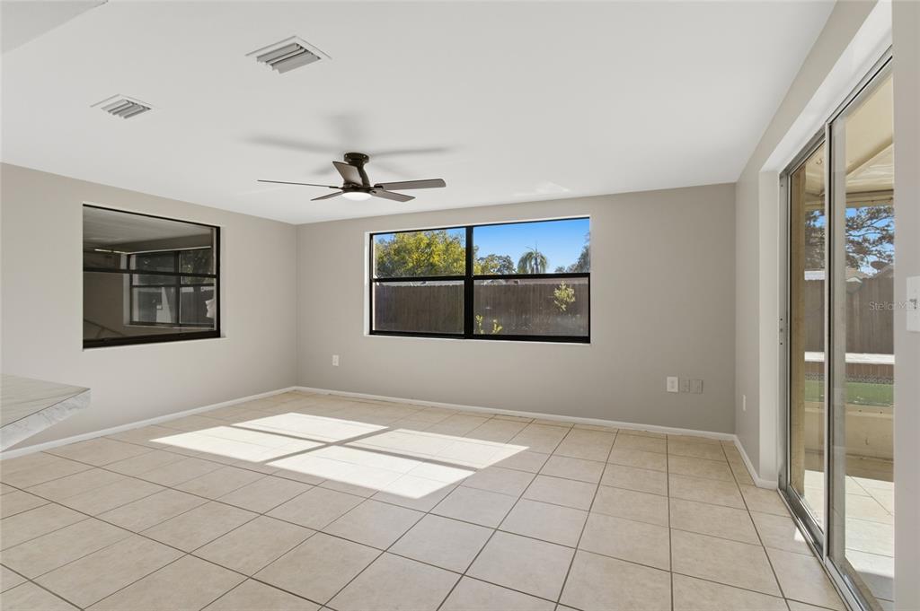 7230 San Moritz Drive Port Richey, FL 34668 - Photo 14 of 25 a view of a livingroom with a chandelier fan and windows
