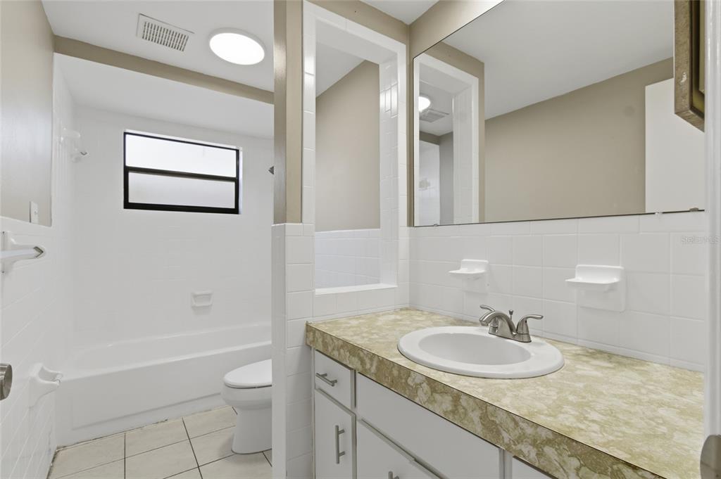 7230 San Moritz Drive Port Richey, FL 34668 - Photo 17 of 25 a bathroom with a granite countertop sink toilet and a mirror