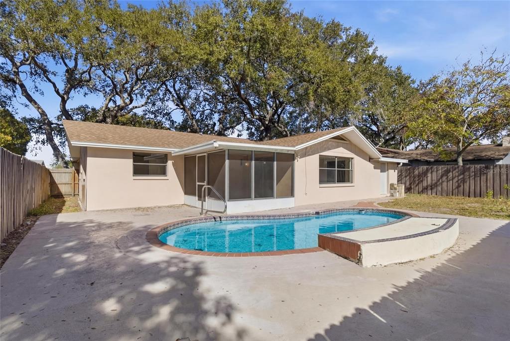 7230 San Moritz Drive Port Richey, FL 34668 - Photo 22 of 25 a front view of house with yard and trees in the background