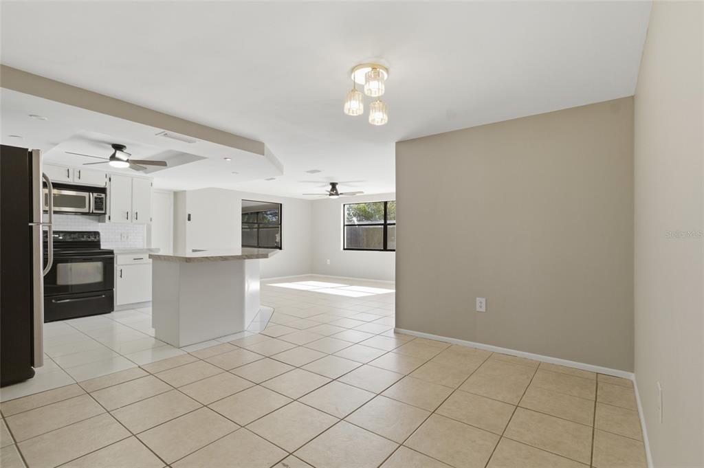 7230 San Moritz Drive Port Richey, FL 34668 - Photo 8 of 25 a view of kitchen with cabinets and window