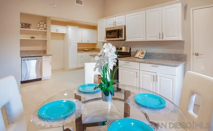 14356 Poway Road Poway, CA 92064 - Photo 1 of 25 a kitchen with stainless steel appliances granite countertop a refrigerator a stove a sink dishwasher and white cabinets with wooden floor