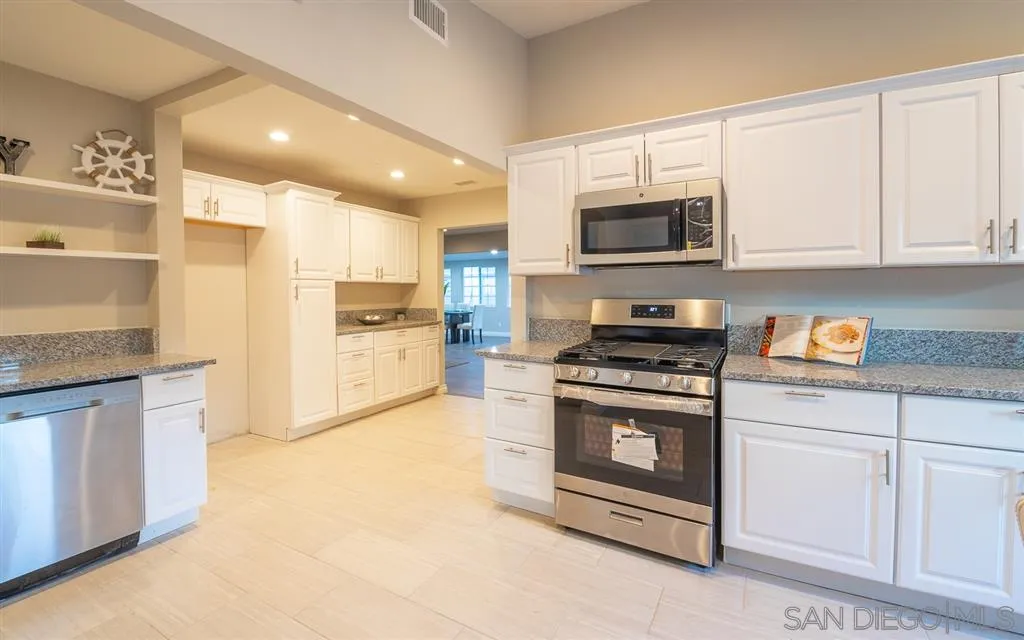14356 Poway Road Poway, CA 92064 - Photo 4 of 25 a kitchen with stainless steel appliances granite countertop a stove a sink and a microwave