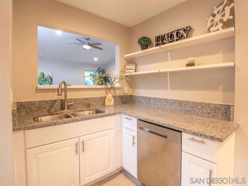 14356 Poway Road Poway, CA 92064 - Photo 5 of 25 a kitchen with cabinets and white stainless steel appliances