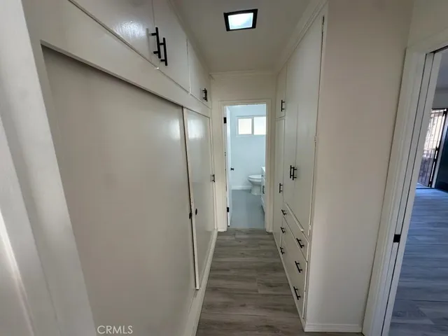 a view of a hallway with wooden floor and staircase