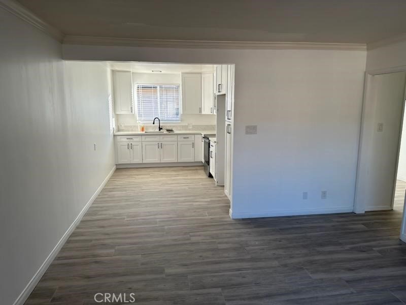 527 Cedar Avenue, Unit 2C Long Beach, CA 90802 - Photo 15 of 29 a view of a kitchen with wooden floor and a sink