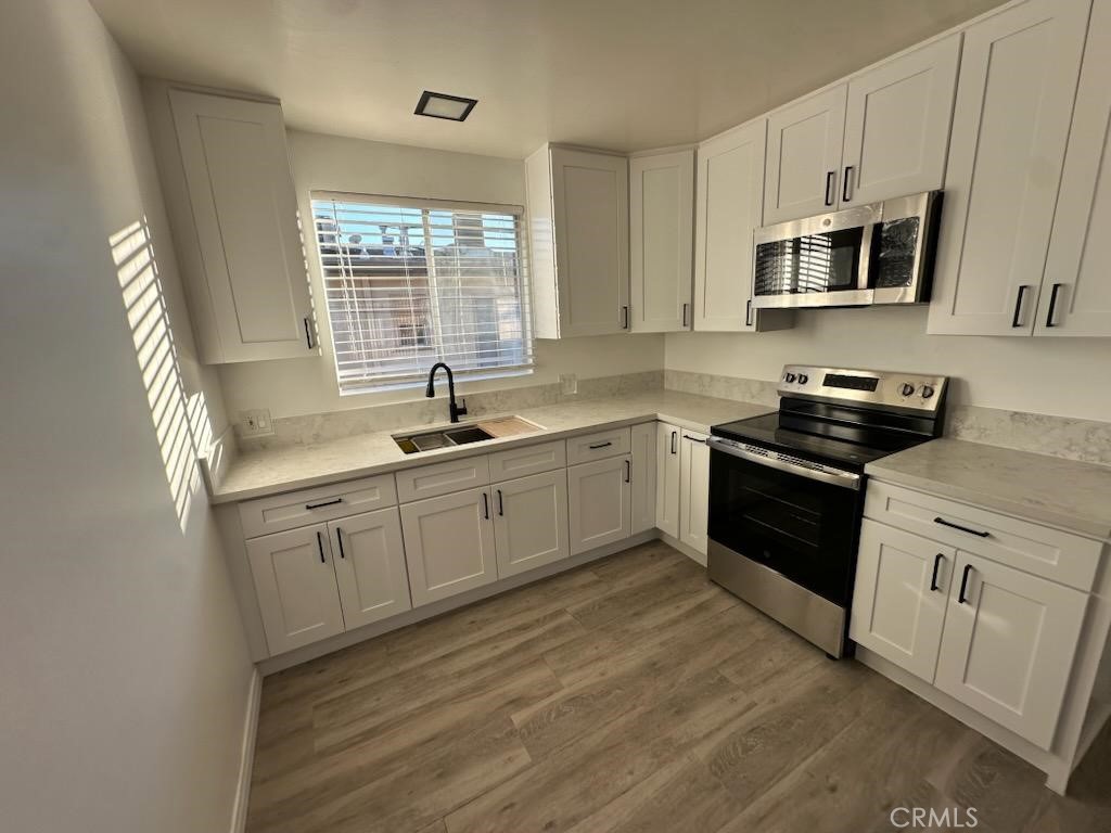 527 Cedar Avenue, Unit 2C Long Beach, CA 90802 - Photo 21 of 29 a kitchen with a sink stove and microwave