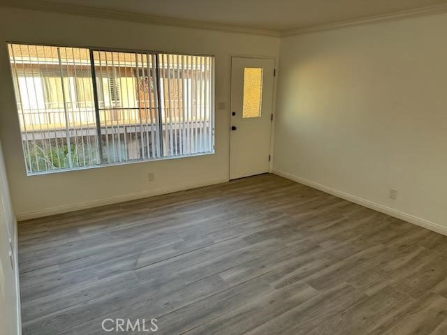 527 Cedar Avenue, Unit 2C Long Beach, CA 90802 - Photo 24 of 29 wooden floor in an empty room with a window