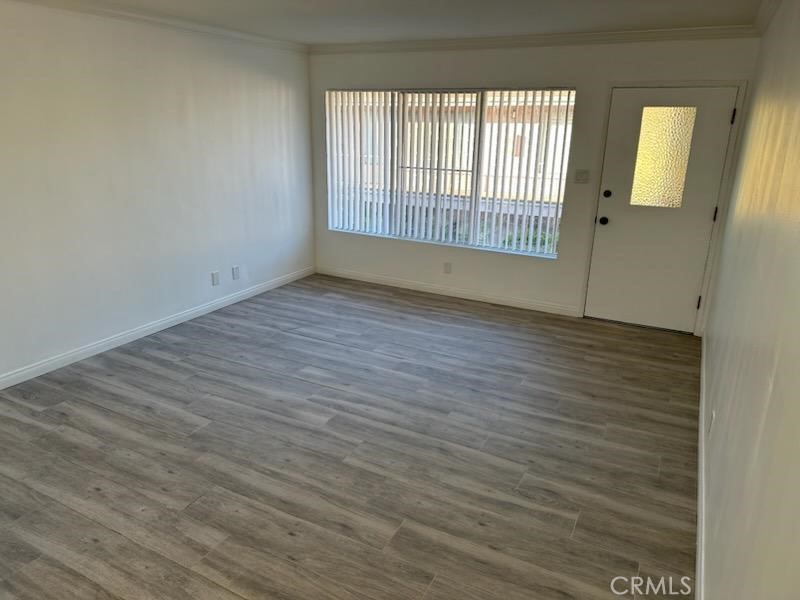 527 Cedar Avenue, Unit 2C Long Beach, CA 90802 - Photo 26 of 29 a view of an empty room with wooden floor and a window