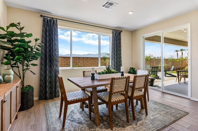 a dining room with furniture window and wooden floor
