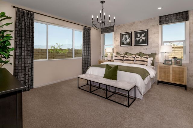 a spacious bedroom with a bed chandelier and window