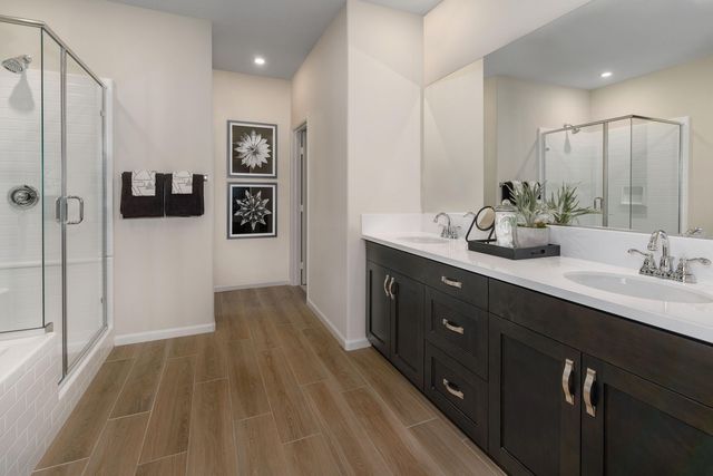 a bathroom with a double vanity sink and mirror