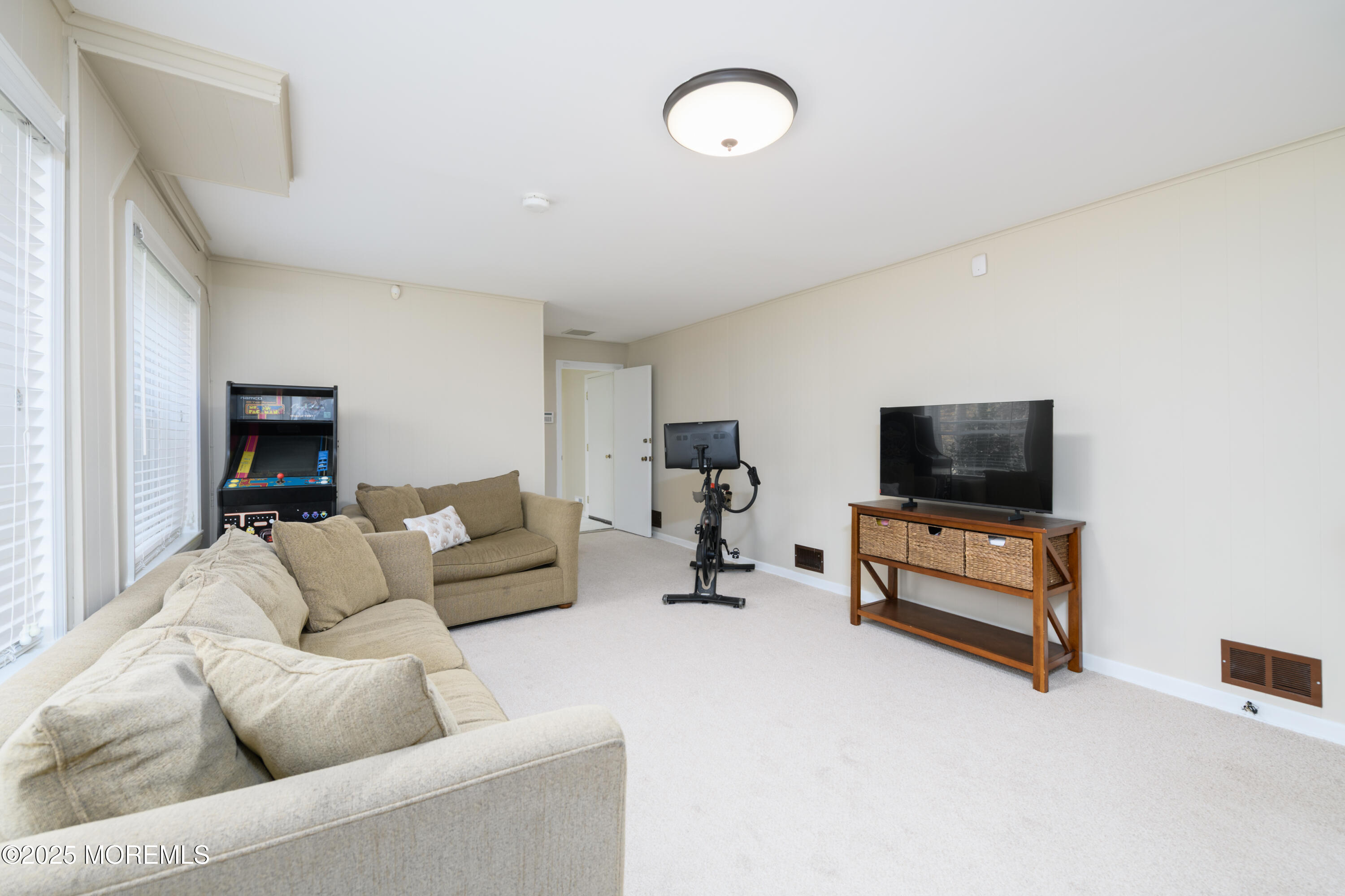 74 Fish Hawk Drive Middletown, NJ 07748 - Photo 17 of 32 a living room with furniture and a flat screen tv