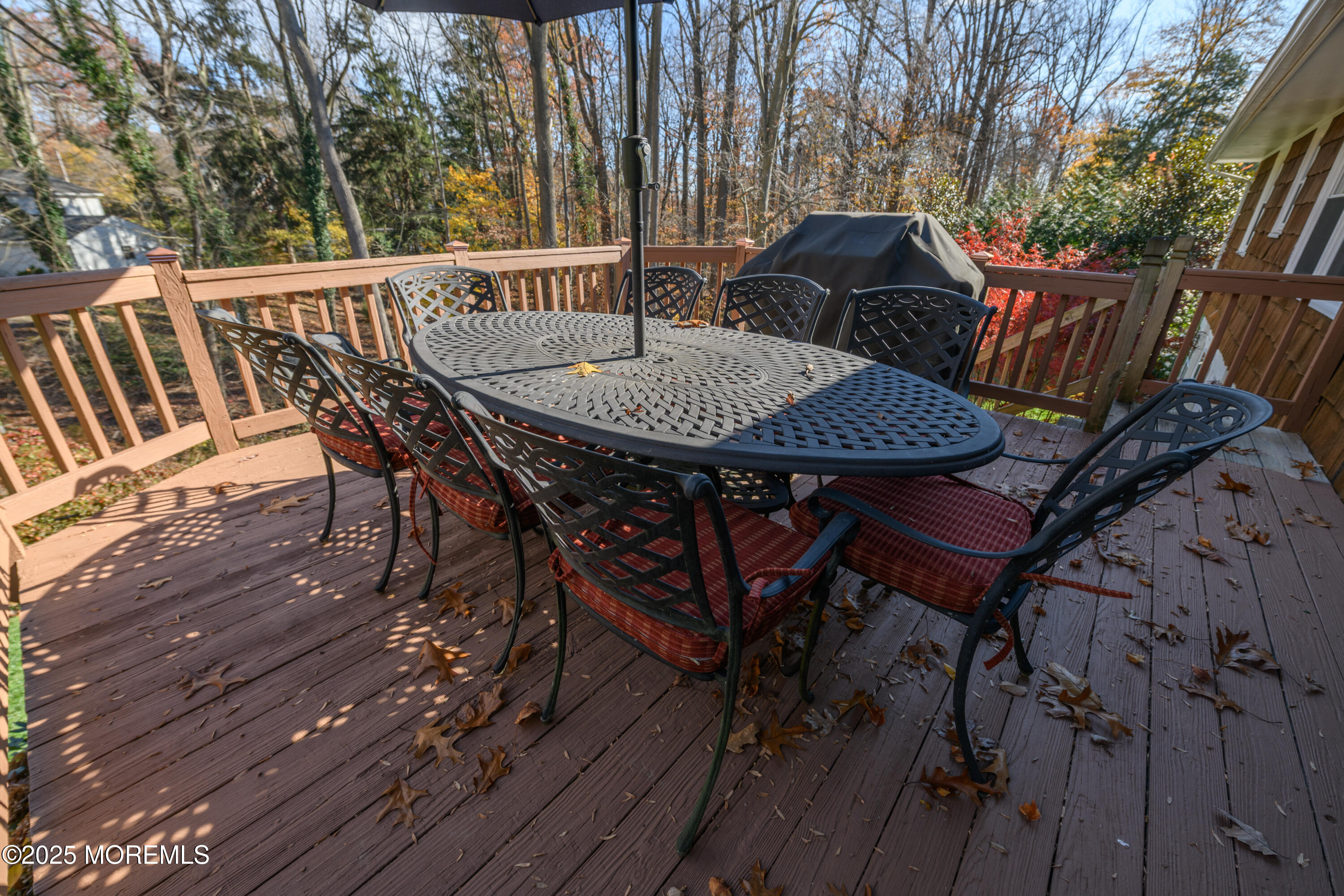 74 Fish Hawk Drive Middletown, NJ 07748 - Photo 20 of 32 a view of a patio with table and chairs with wooden floor and fence