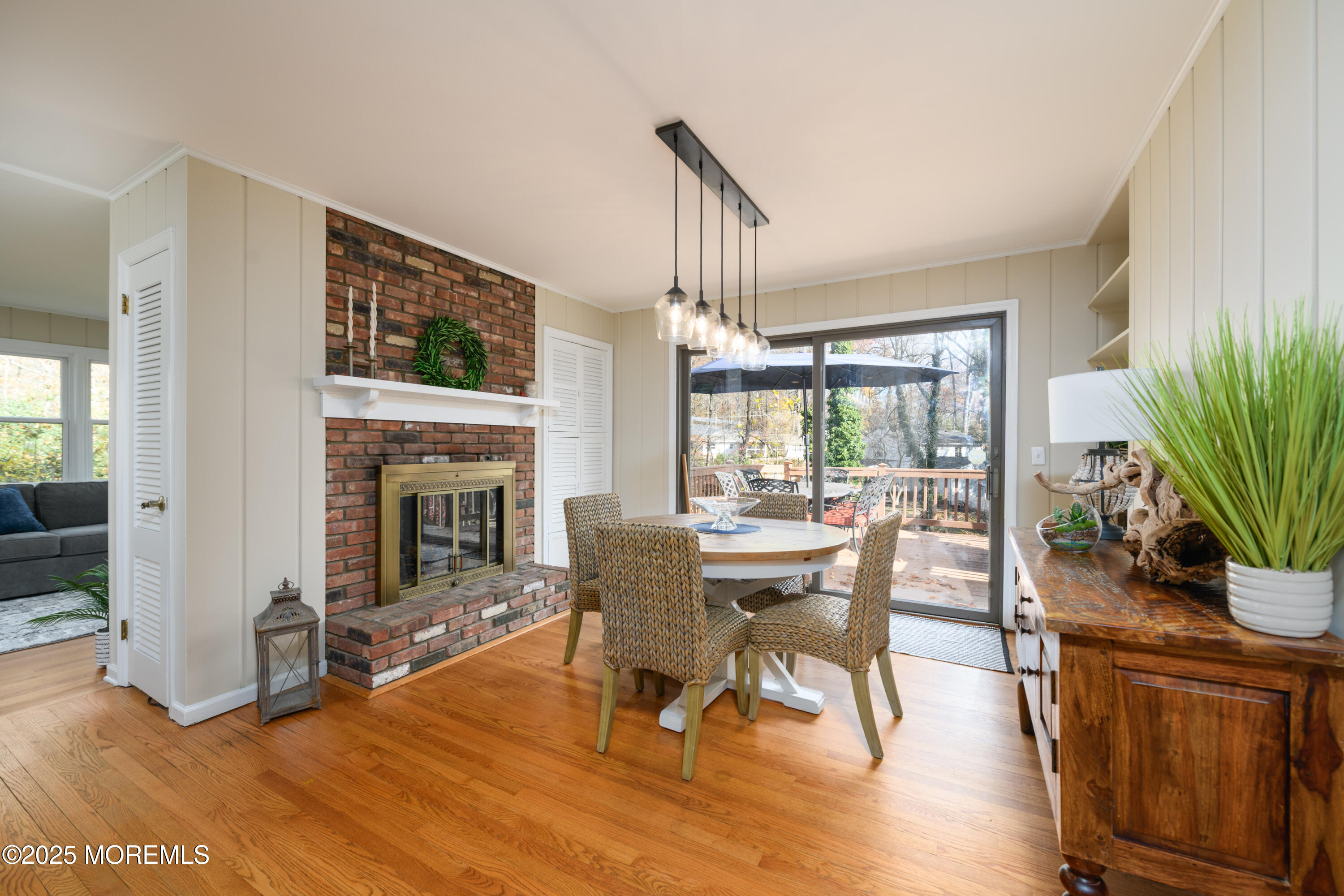 74 Fish Hawk Drive Middletown, NJ 07748 - Photo 6 of 32 a dining room with furniture a fireplace and wooden floor