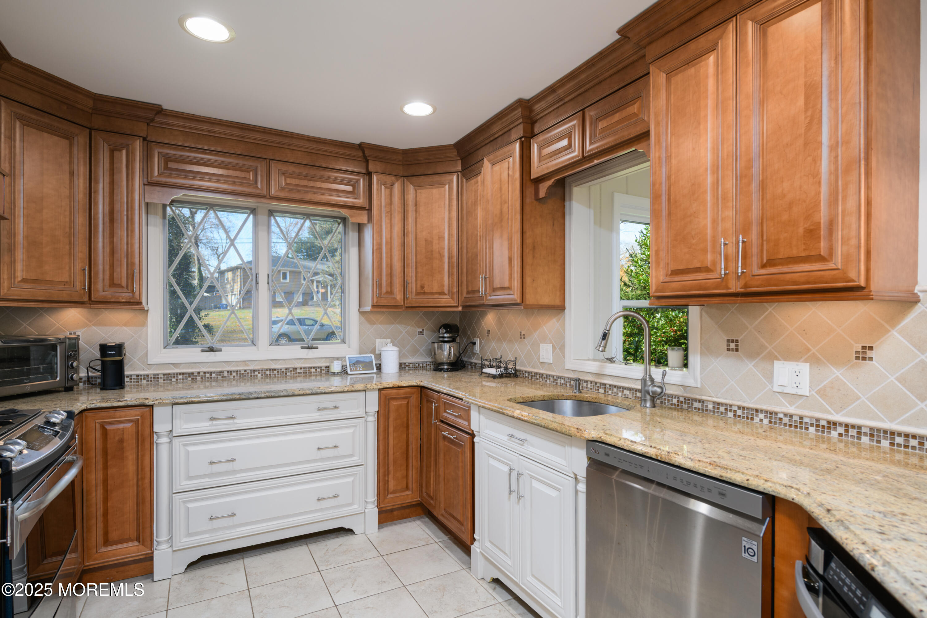 74 Fish Hawk Drive Middletown, NJ 07748 - Photo 8 of 32 a kitchen with granite countertop a sink stainless steel appliances and cabinets