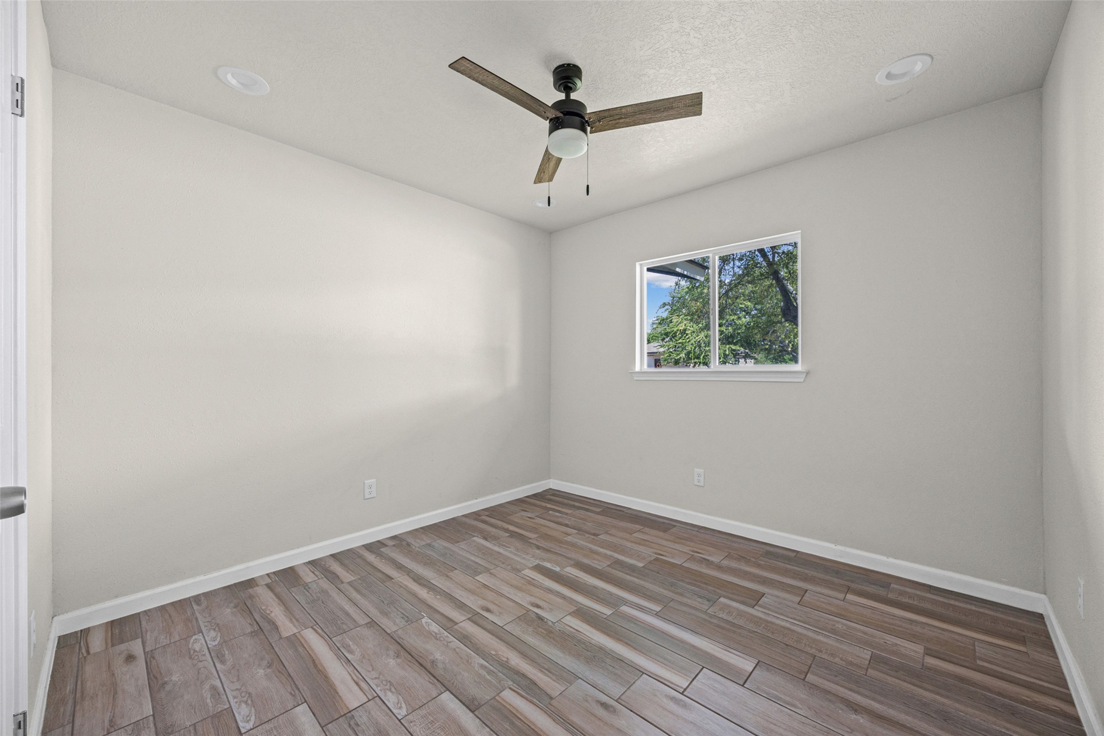 1531 Lahn Road New Braunfels, TX 78130 - Photo 19 of 33 Wood-look tile floors and recessed lighting enhance this versatile bedroom space.
