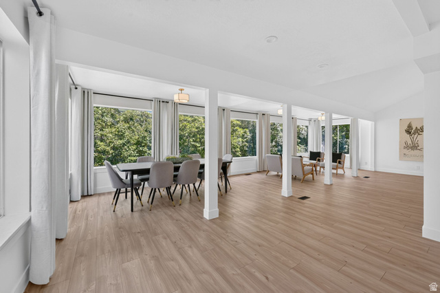 1979 Cave Hollow Way Bountiful, UT 84010 - Photo 17 of 59 Expansive room featuring wood-finish flooring, abundant natural light from multiple windows, and a vaulted ceiling