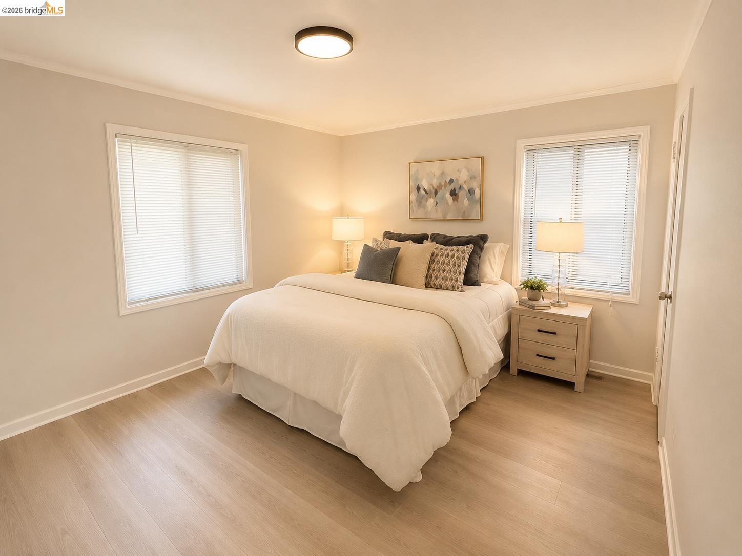 810 Pierce Street Albany, CA 94706 - Photo 7 of 25 Bedroom featuring light wood-finish flooring, two windows with blinds, a ceiling-mounted light fixture, and crown molding