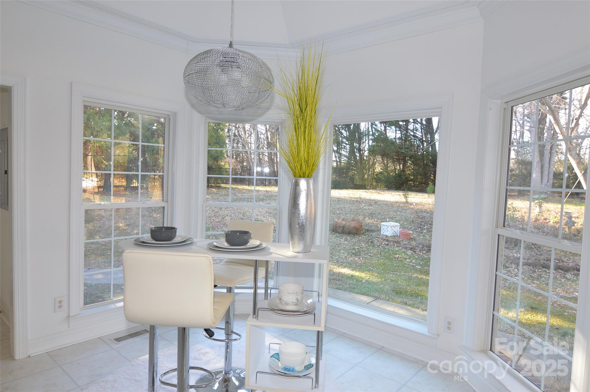 125 Eaglecrest Drive Matthews, NC 28104 - Photo 15 of 28 a view of a dining room with furniture water view and a floor to ceiling window